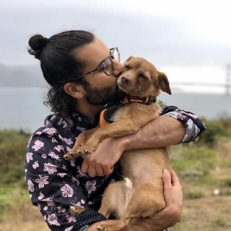 Danny, the founder of GetSetReply, holding his dog outdoors